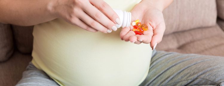 woman hand holding pills for improve of iron level in blood. Receiving vitamins in pregnancy time, Healthy millennial healthcare concept.