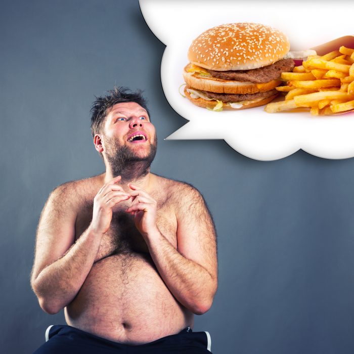 Fat funny man dreaming about  hamburger isolated on gray